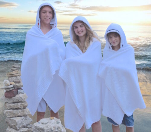 Family wearing hooded towels