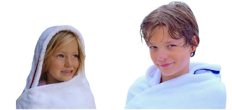Two children wearing hooded towels